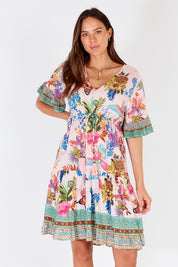 A model wearing the Caatinga Dress in colour Pink (Pink), from the front, cropped image