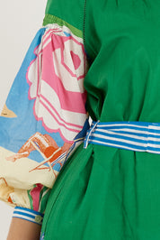 A model wearing the Cote D'azur Cotton Dress in colour Print (Green), from the front, cropped image