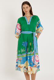 A model wearing the Cote D'azur Cotton Dress in colour Print (Green), from the front, cropped image