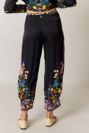 Model Genericm wearing size sample of the Delicia Pant – Black in colour Black, from the back