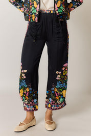 Model Genericm wearing size sample of the Delicia Pant – Black in colour Black, from the front