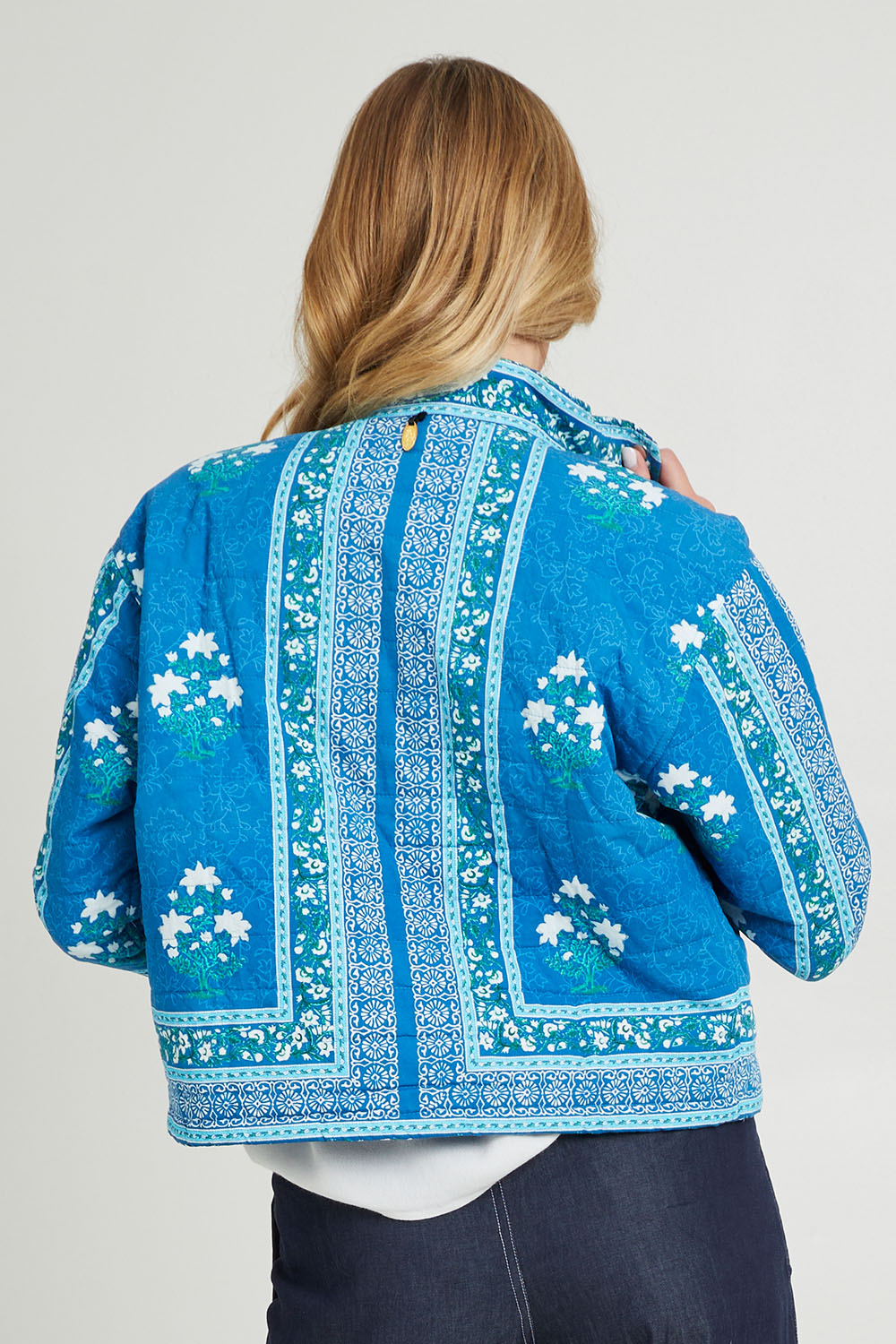 Model Grace wearing size S of the Kiana Jacket in colour Blue (Blue), from the back