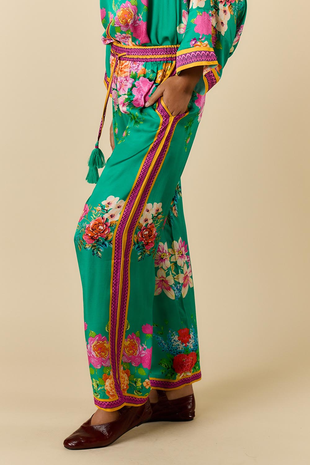Model Genericm wearing size sample of the Liberte Pant – Green in colour Green, from an angle