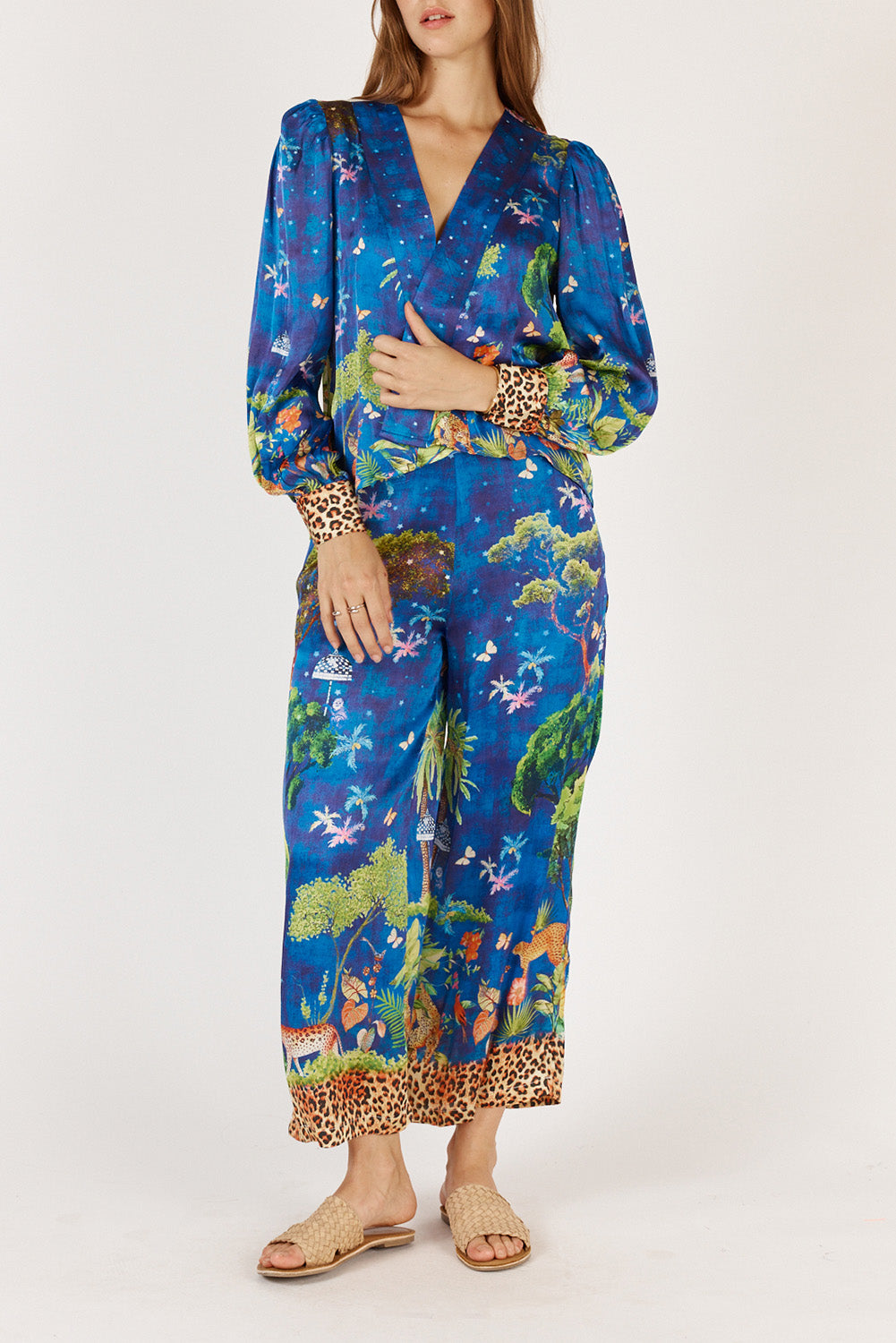 A model wearing the Mataram Bolero in colour Navy, from the front, cropped image