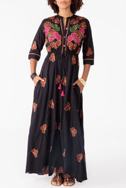 A model wearing the Miguel Cotton Dress in colour Black (Black), from the front, cropped image