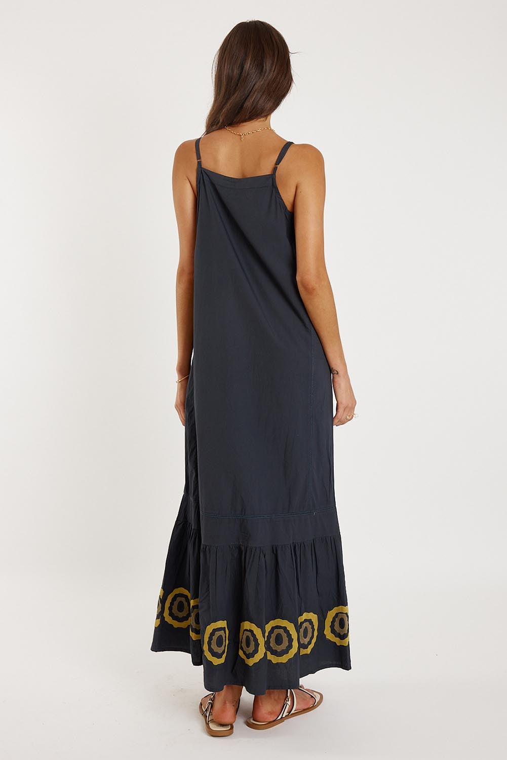 A model wearing the Monoki Cotton Dress in colour Black (Black), from the back