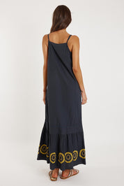 A model wearing the Monoki Cotton Dress in colour Black (Black), from the back