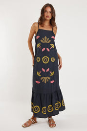 A model wearing the Monoki Cotton Dress in colour Black (Black), from the front, showing the whole outfit
