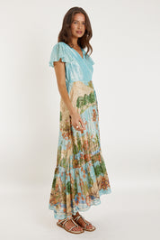 A model wearing the Montpellier Wrap Dress in colour Print (Blue), from the front, showing the whole outfit