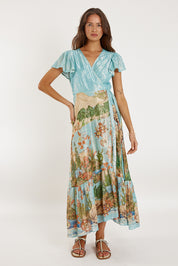 A model wearing the Montpellier Wrap Dress in colour Print (Blue), from the front, showing the whole outfit