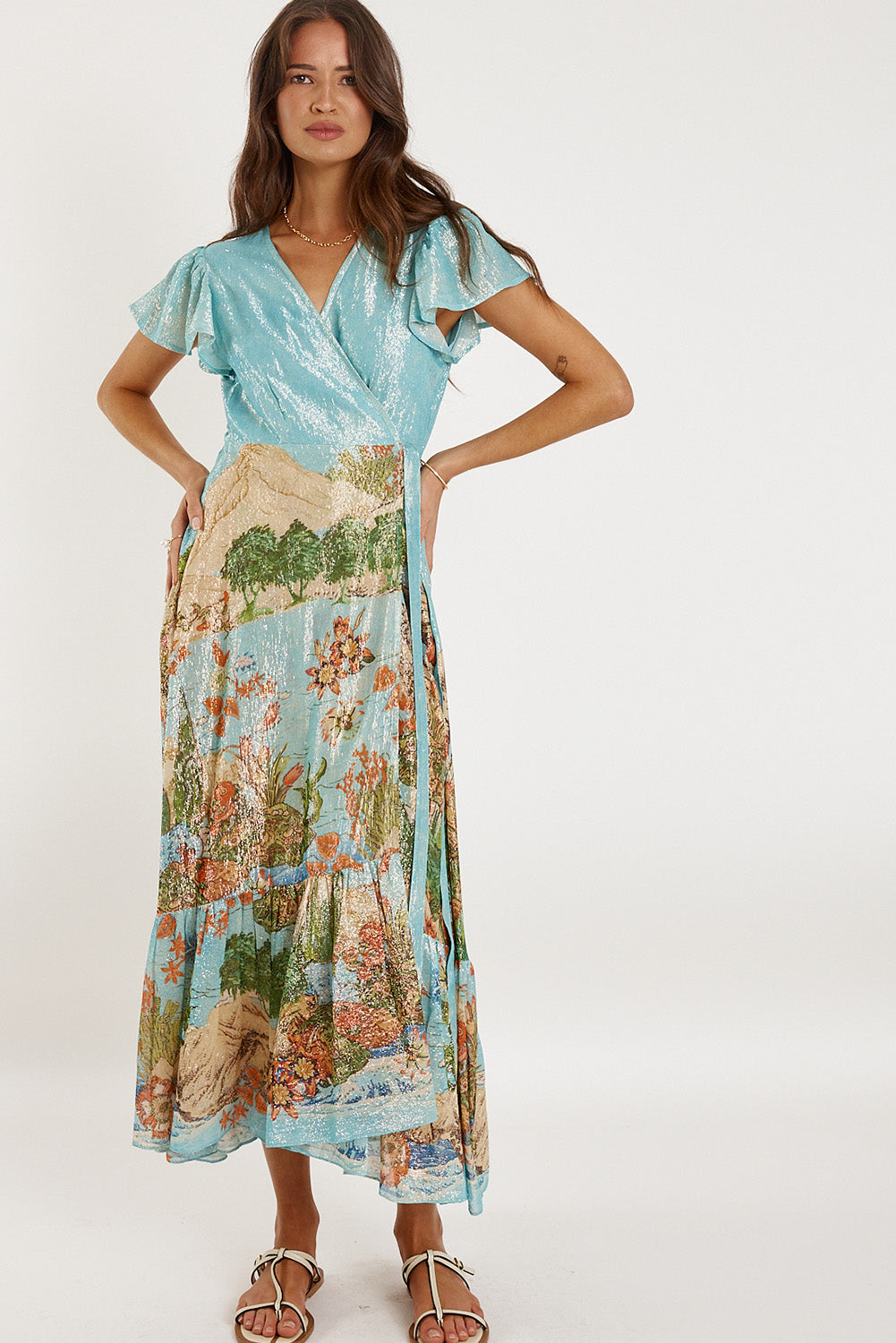 A model wearing the Montpellier Wrap Dress in colour Print (Blue), from the front, showing the whole outfit