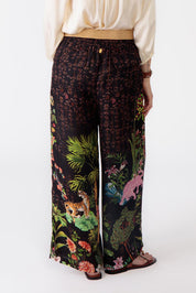 A model wearing the Nouveau Pant in colour Black (Black), from the back