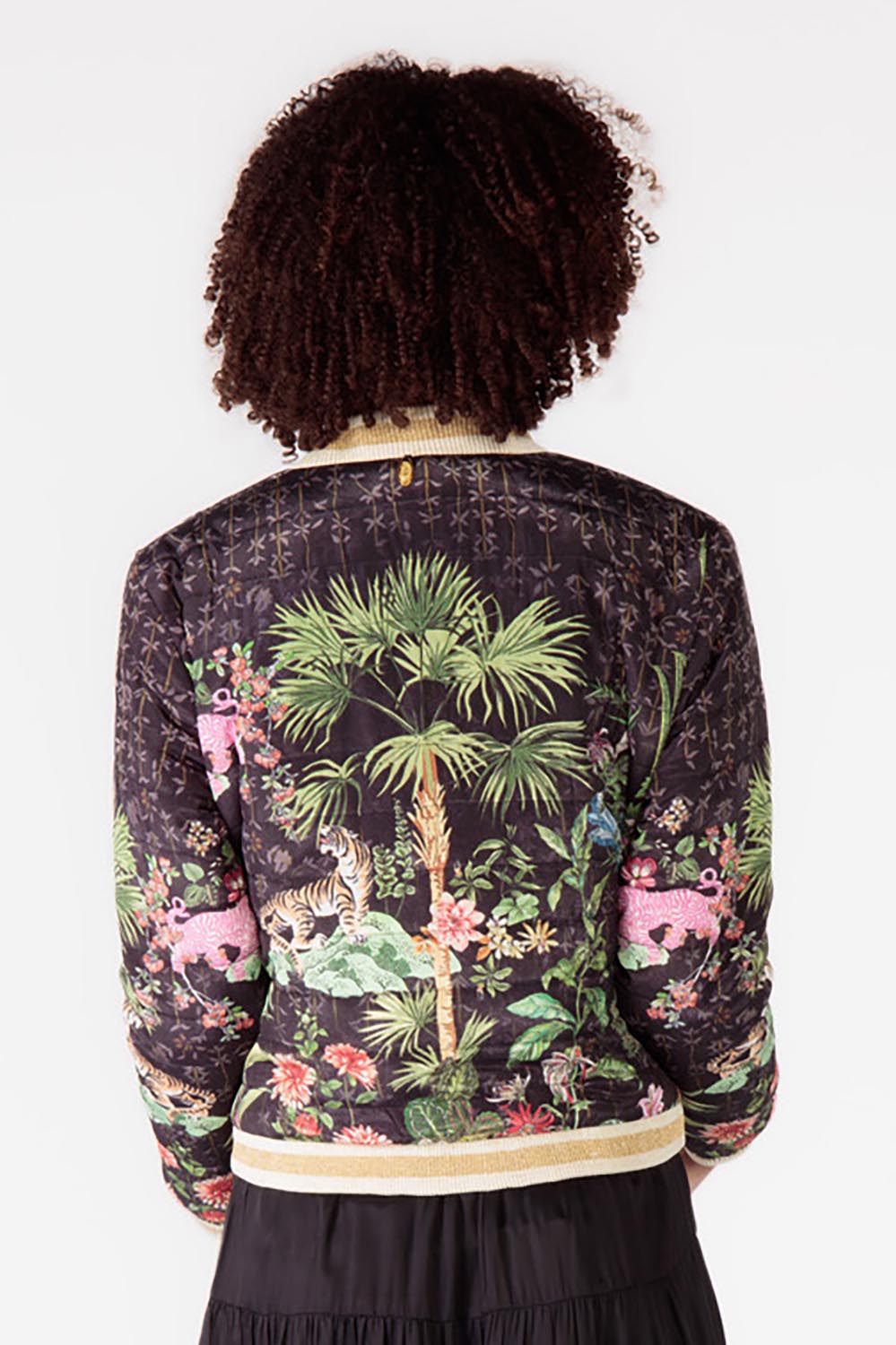 A model wearing the Nouveau Quilted Jacket in colour Black (Black), from the back