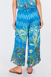 A model wearing the Palm Springs Pant in colour Blue (Blue), from the back