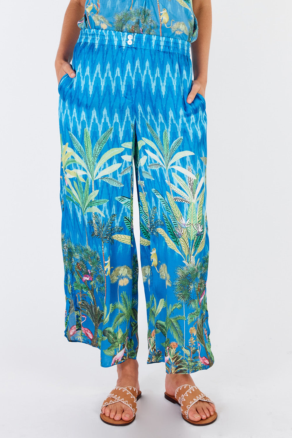 A model wearing the Palm Springs Pant in colour Blue (Blue), from the front, cropped image