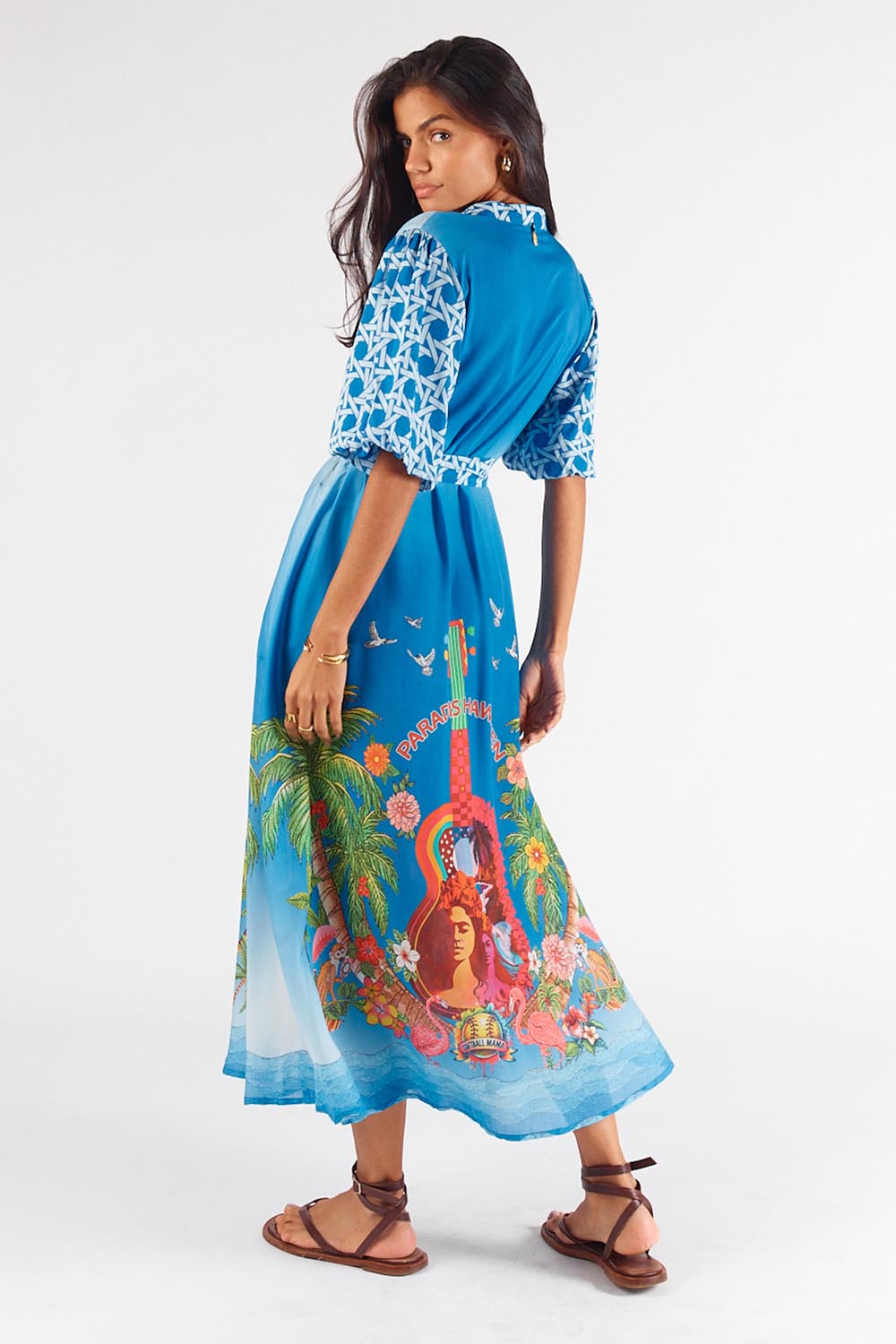 A model wearing the Paradis Maxi Dress in colour Blue (Blue), from the back