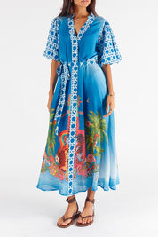 A model wearing the Paradis Maxi Dress in colour Blue (Blue), from the front, cropped image