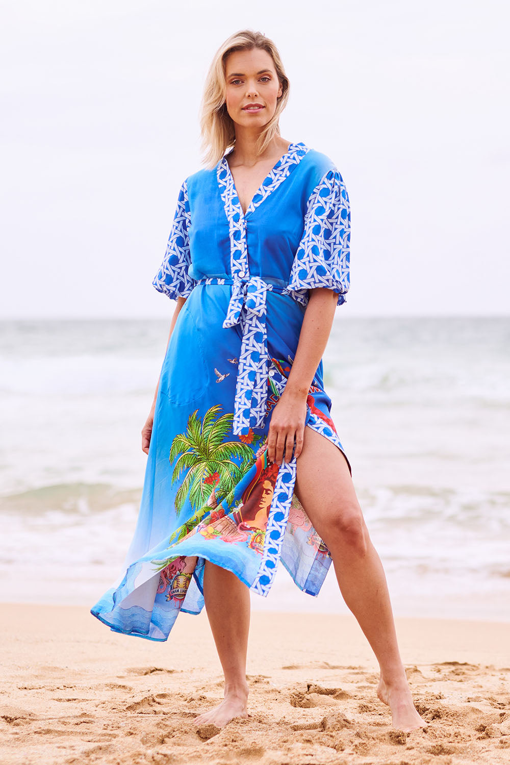 Model Phoebe wearing size S of the Paradis Maxi Dress in colour Blue (Blue), from the front, showing the whole outfit