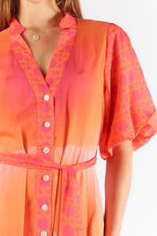 A model wearing the Paradis Maxi Dress in colour Pink (Pink), from the front, cropped image