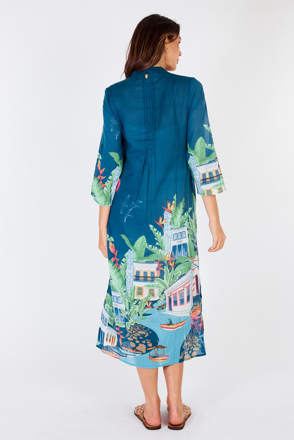A model wearing the Paraty Cotton Kaftan Dress in colour Multi (Blue), from the back