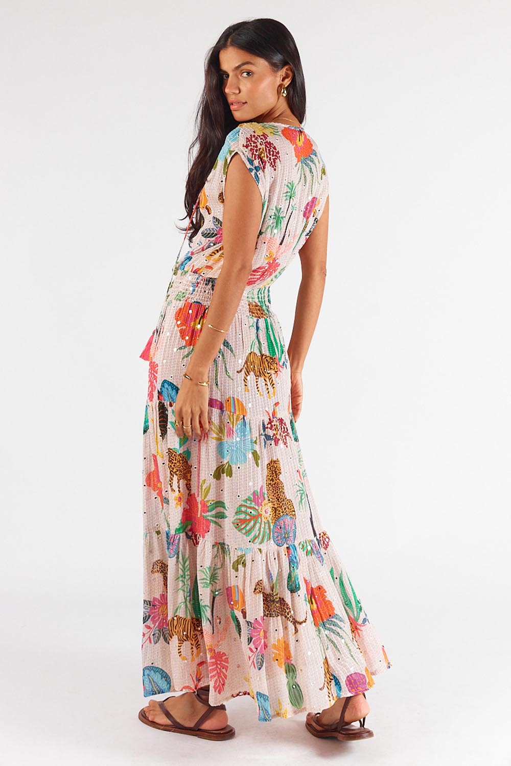 A model wearing the Pretoria Maxi Dress in colour Cream, from the back