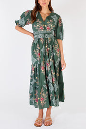 A model wearing the Primavera Cotton Maxi Dress in colour Olive (Green), from the front, cropped image
