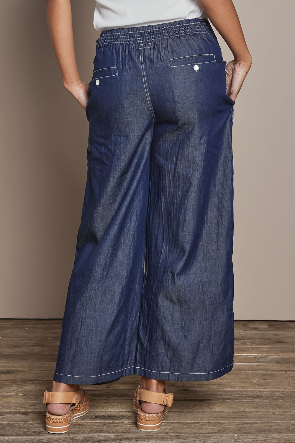 Model Ziara wearing size S of the Pula Pant in colour Denim (Blue), from the back