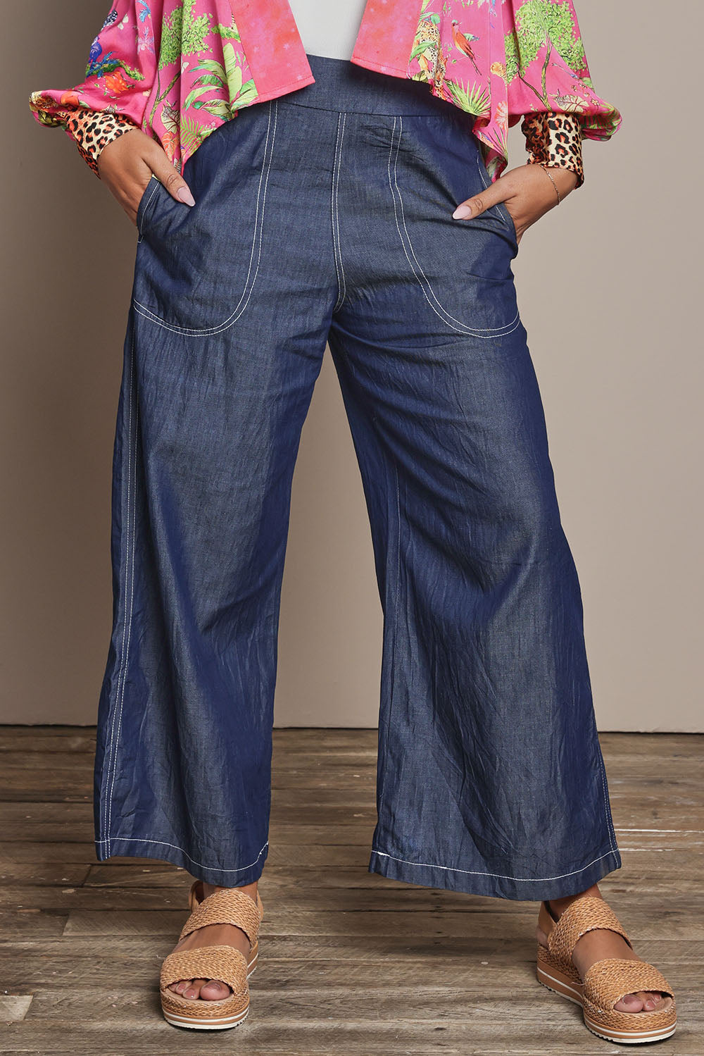 Model Ziara wearing size S of the Pula Pant in colour Denim (Blue), from the front, cropped image
