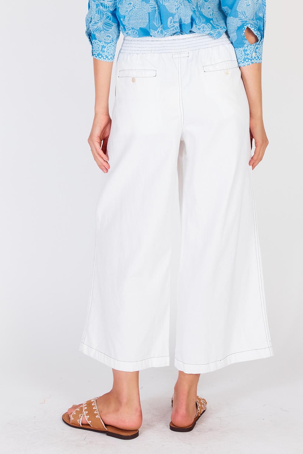A model wearing the Pula Pant in colour White (White), from the back