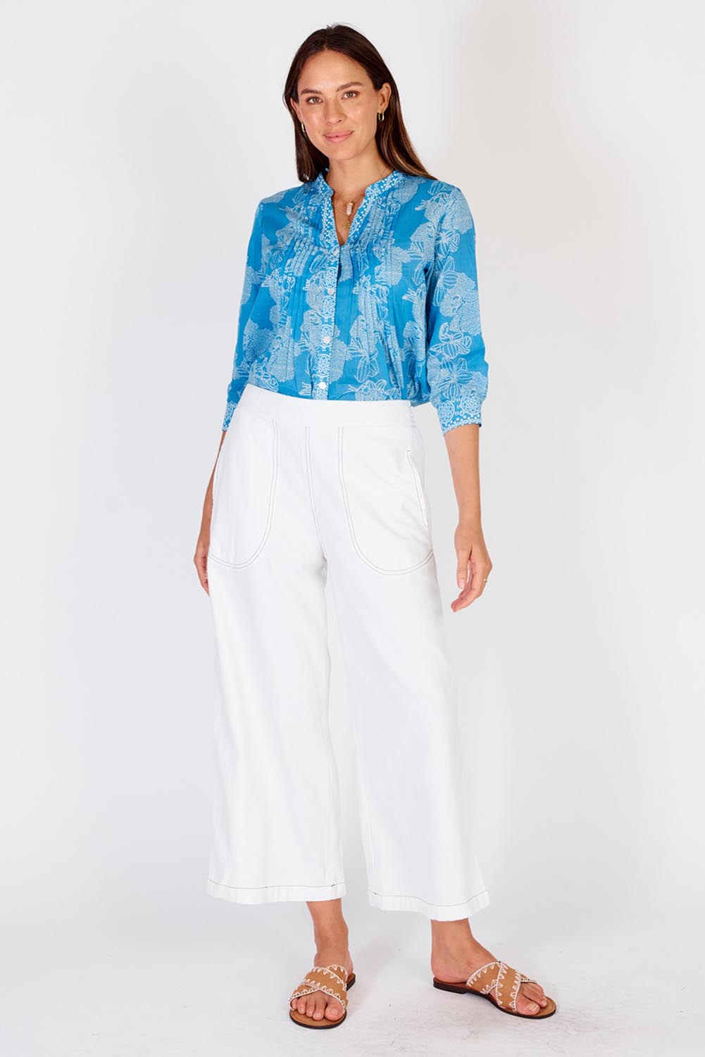 A model wearing the Pula Pant in colour White (White), from the front, showing the whole outfit