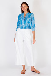 A model wearing the Pula Pant in colour White (White), from the front, showing the whole outfit