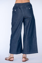 Model Genericm wearing size sample of the Pula Pant – Denim in colour Denim, from the back