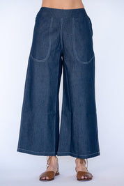 Model Genericm wearing size sample of the Pula Pant – Denim in colour Denim, in a cropped view