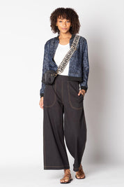 A model wearing the Pula Denim Pant in colour Black (Black), from the front, showing the whole outfit