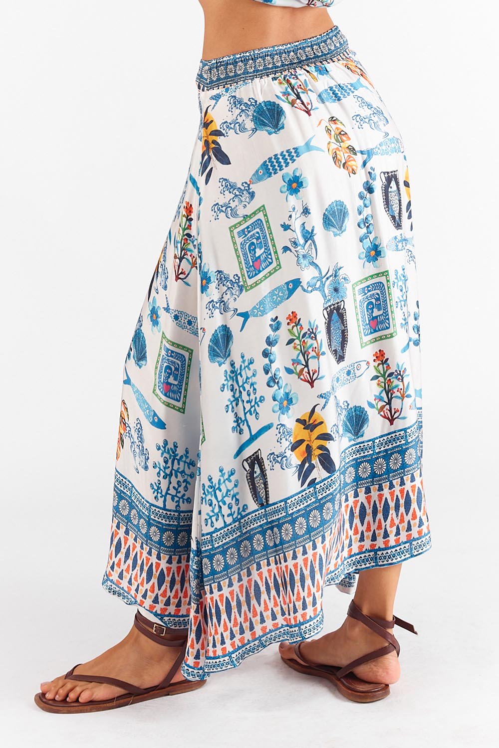 A model wearing the Sardinia Skirt in colour Multi (Blue), from the back