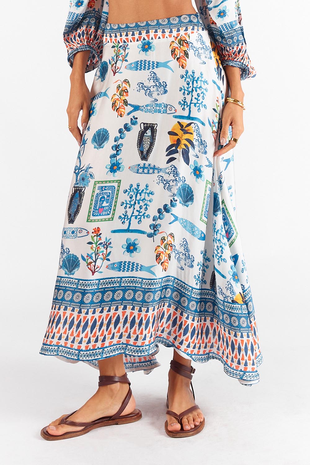 A model wearing the Sardinia Skirt in colour Multi (Blue), from the front, cropped image