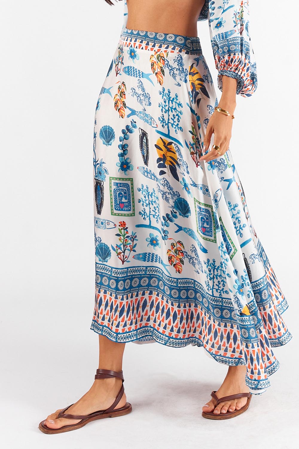 A model wearing the Sardinia Skirt in colour Multi (Blue), from the front, cropped image