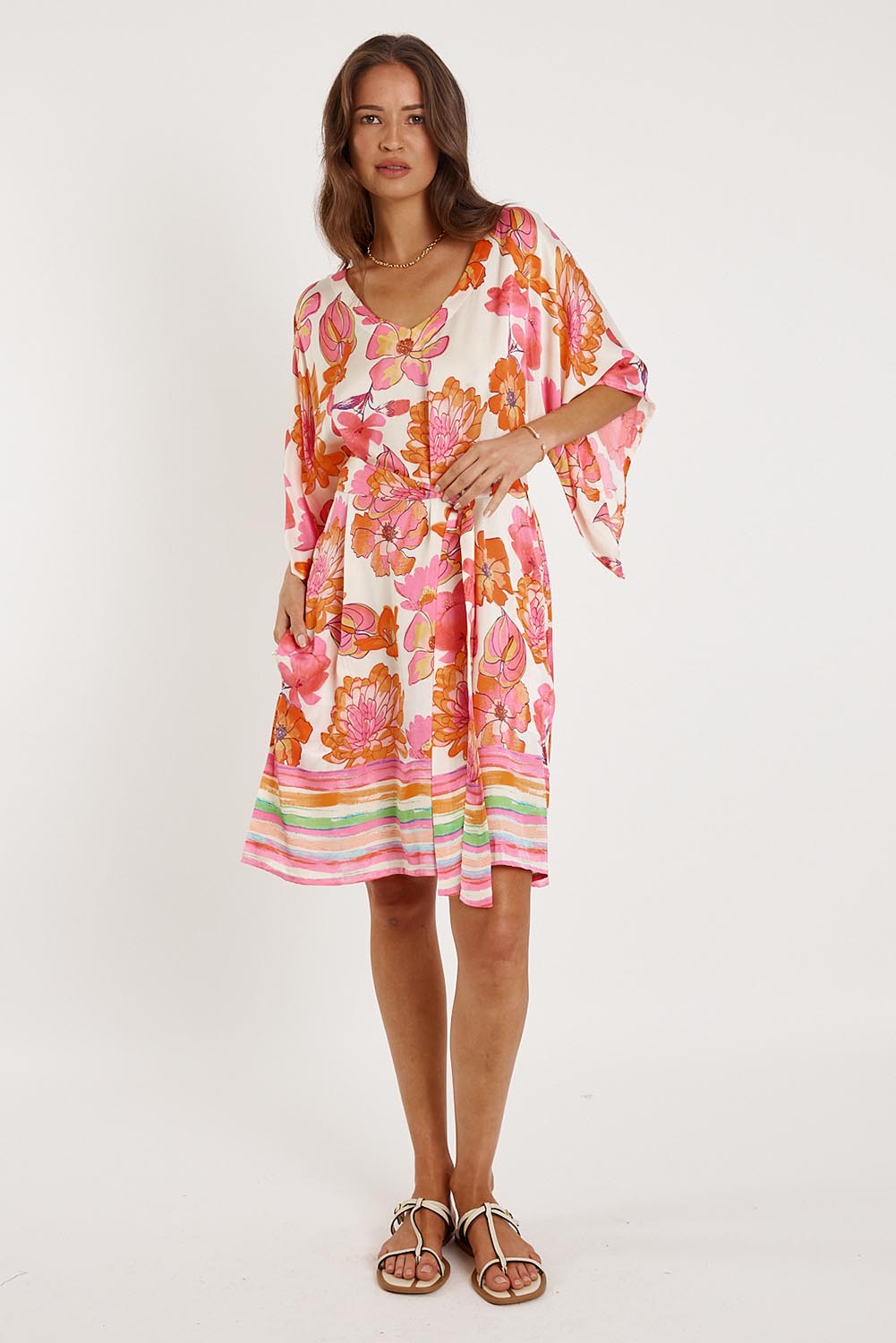 A model wearing the Sunrise Dress in colour Pink (Pink), from the front, showing the whole outfit