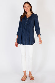 A model wearing the Sunrise Cotton Shirt in colour Navy (Blue), from the front, showing the whole outfit
