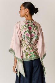 Model Genericm wearing size sample of the Tatiana Poncho – Pink in colour Pink, from the back