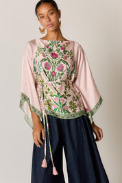 Model Genericm wearing size sample of the Tatiana Poncho – Pink in colour Pink, in a cropped view