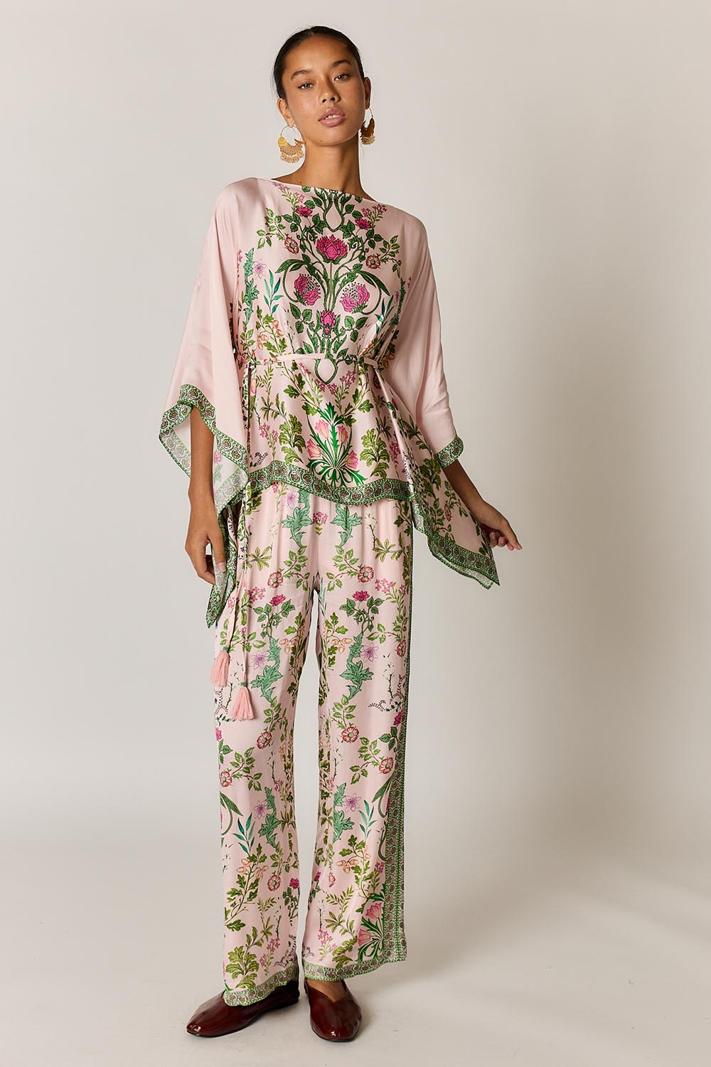 Model Genericm wearing size sample of the Tatiana Poncho – Pink in colour Pink, from the front