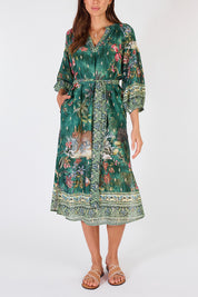 A model wearing the Le Tigre Dress in colour Greenmulti (Green), from the front, cropped image