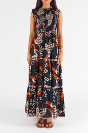 A model wearing the Toucan Cotton Maxi Dress in colour Multi (Black), from the front, cropped image