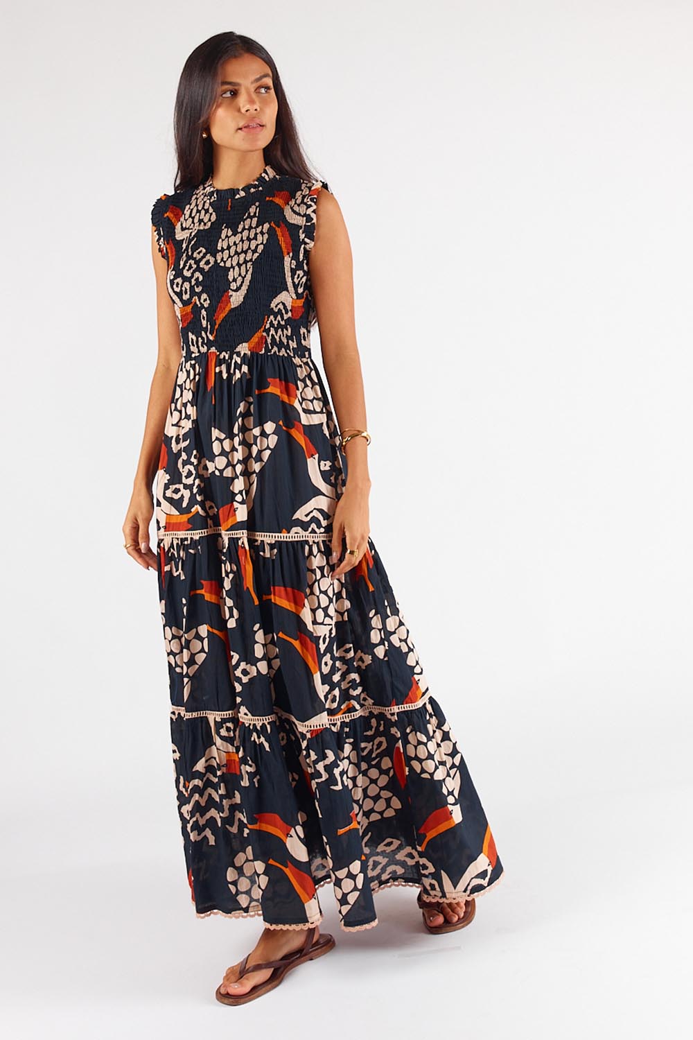 A model wearing the Toucan Cotton Maxi Dress in colour Multi (Black), from the front, showing the whole outfit