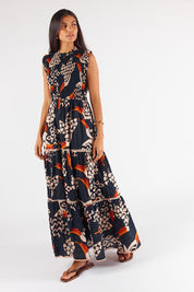 A model wearing the Toucan Cotton Maxi Dress in colour Multi (Black), from the front, showing the whole outfit