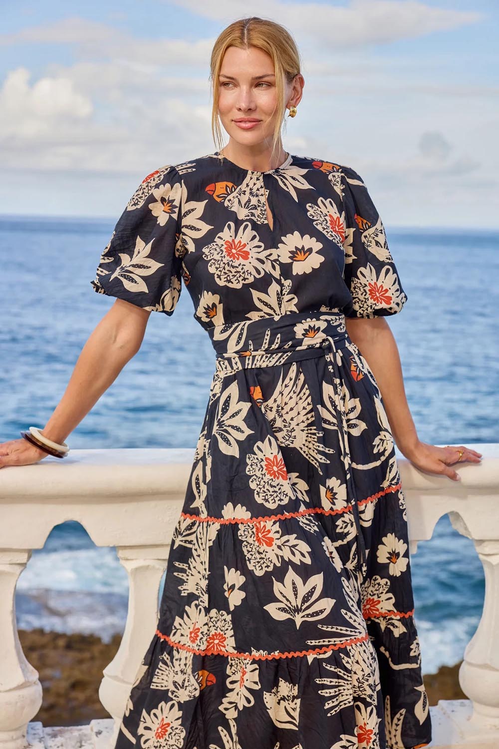Model Genericm wearing size sample of the Tucan Cotton Maxi Dress – Black in colour Black, in a cropped view