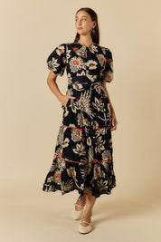 Model Genericm wearing size sample of the Tucan Maxi Dress – Black in colour Black, from the front