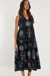 A model wearing the Waratah Cotton Dress in colour Print (Black), from the front, showing the whole outfit