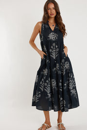A model wearing the Waratah Cotton Dress in colour Print (Black), from the front, showing the whole outfit
